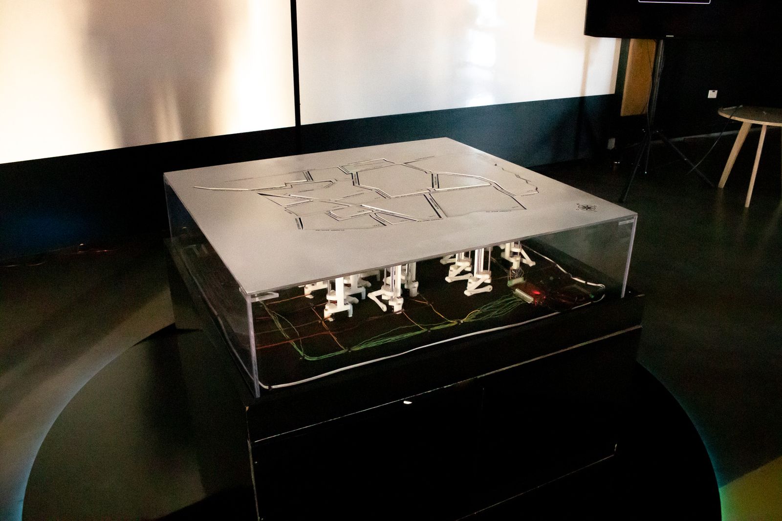 Side view of the table showing the acrylic case and the mechanisms underneath